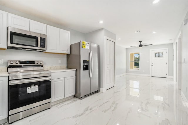 kitchen with marble finish floor, white cabinetry, recessed lighting, stainless steel appliances, and light countertops