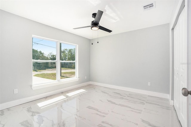 spare room featuring visible vents, baseboards, and marble finish floor