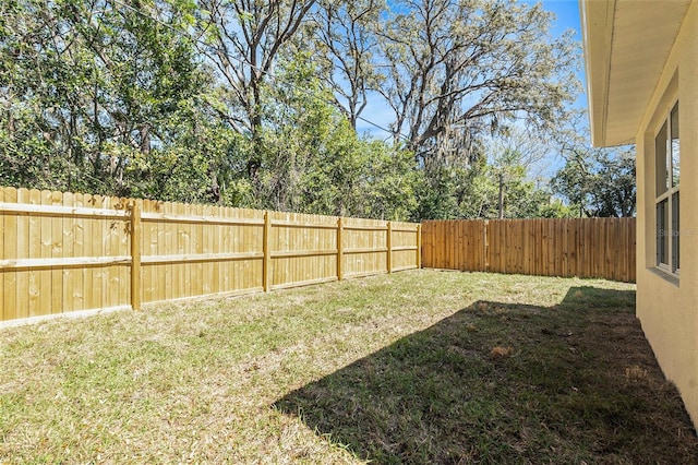 view of yard with a fenced backyard