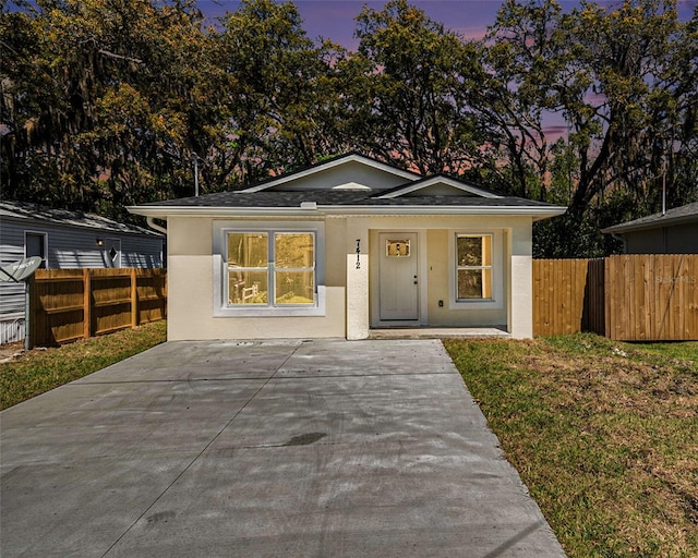 view of front of property featuring a porch, fence, and stucco siding