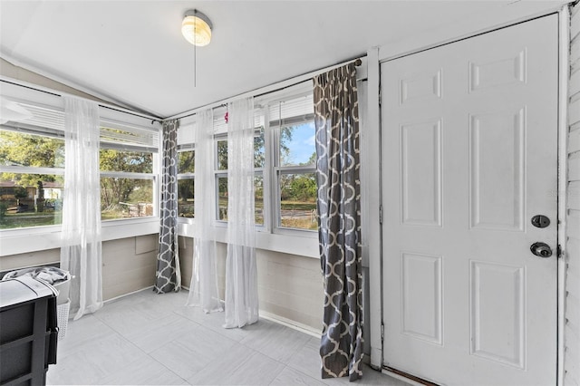 sunroom with a wealth of natural light and vaulted ceiling