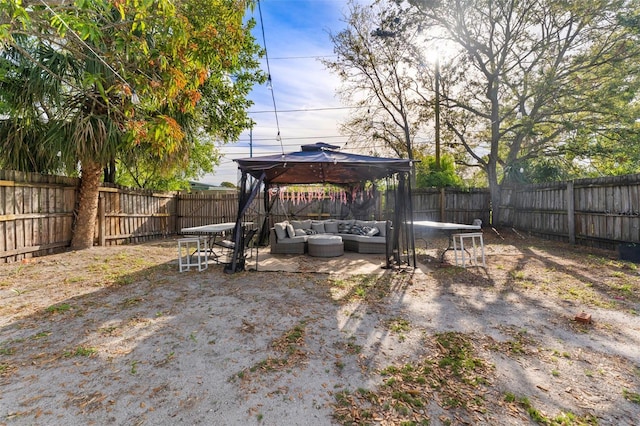 view of yard featuring a gazebo, an outdoor hangout area, a patio, and a fenced backyard