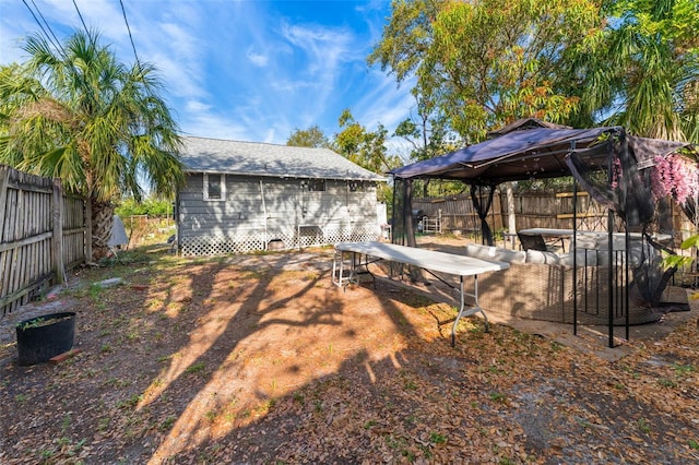 view of yard featuring a gazebo and a fenced backyard