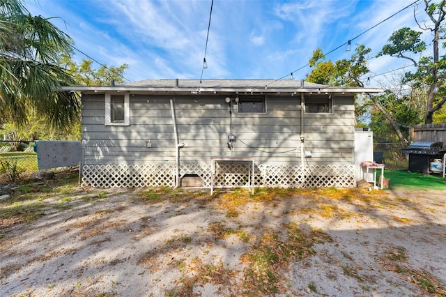 view of side of property with entry steps and fence