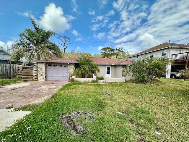 view of front facade with a front yard, stairway, a garage, and driveway