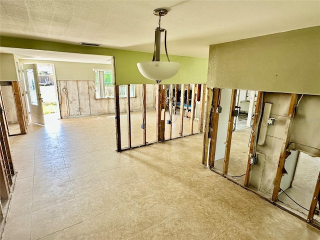 interior space featuring visible vents and a textured ceiling