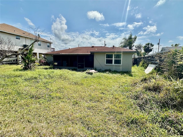 back of house with fence and a sunroom