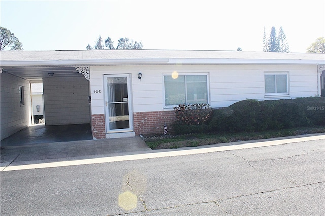 exterior space featuring an attached carport and brick siding