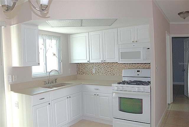 kitchen with white appliances, a sink, light countertops, white cabinetry, and tasteful backsplash