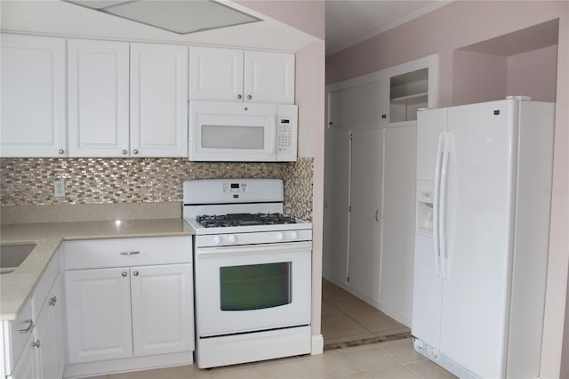 kitchen featuring white appliances, light tile patterned flooring, light countertops, white cabinets, and backsplash