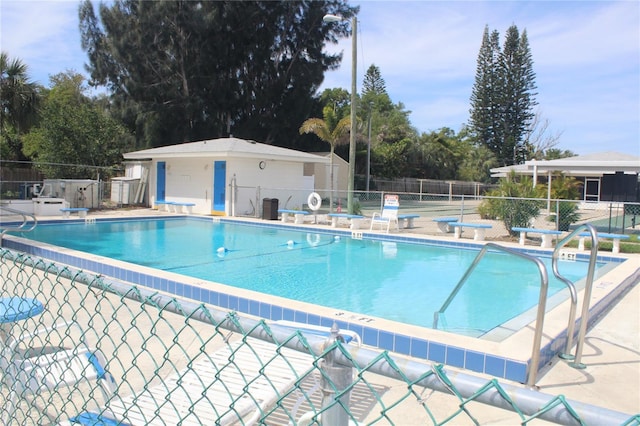 pool featuring a patio area and fence