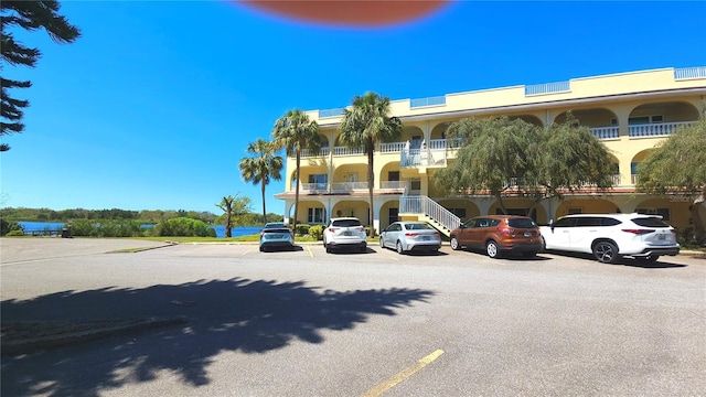 view of building exterior with uncovered parking