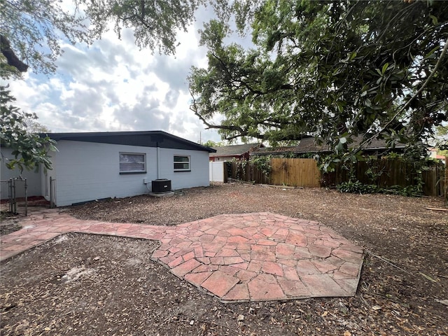 back of property featuring central air condition unit, a patio, and fence