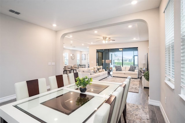 dining area featuring recessed lighting, visible vents, arched walkways, and wood finish floors