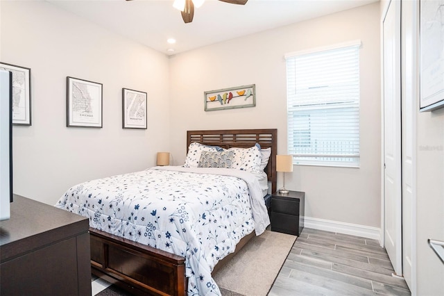 bedroom with recessed lighting, ceiling fan, baseboards, and wood finished floors