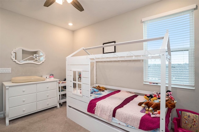 bedroom featuring recessed lighting, light colored carpet, a ceiling fan, and multiple windows