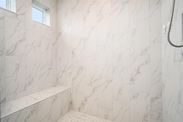 bathroom with a marble finish shower