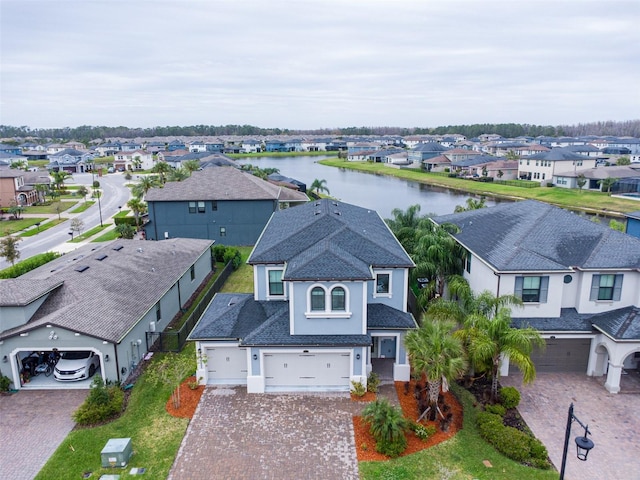 birds eye view of property with a residential view and a water view