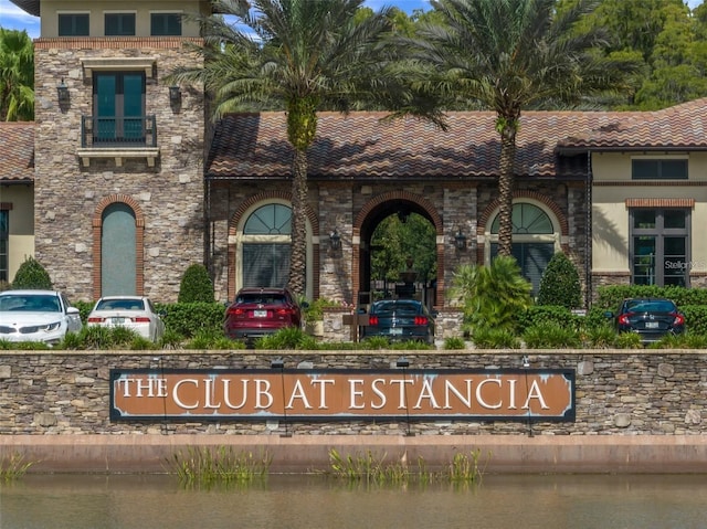 exterior details with brick siding, stucco siding, and a tile roof