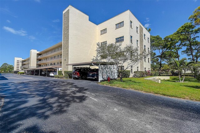 5920 80th St N Unit 107, Saint Petersburg, FL 33709 - view of building exterior with covered parking