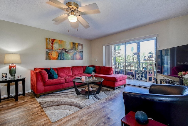 5920 80th St N Unit 107, Saint Petersburg, FL 33709 - living room with baseboards, wood finished floors, a textured ceiling, and ceiling fan