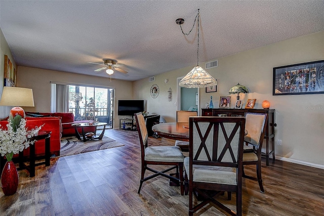 5920 80th St N Unit 107, Saint Petersburg, FL 33709 - dining room with a textured ceiling, wood finished floors, visible vents, and ceiling fan
