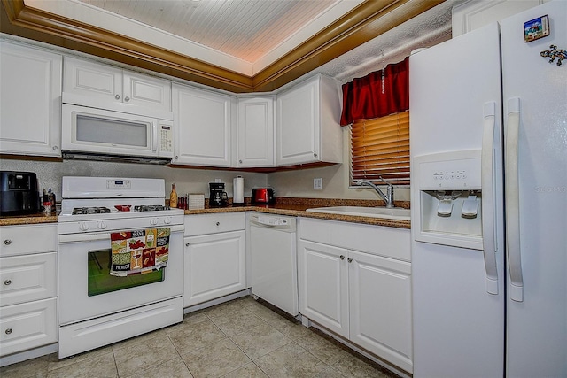 5920 80th St N Unit 107, Saint Petersburg, FL 33709 - kitchen featuring white cabinets, a sink, a raised ceiling, white appliances, and light tile patterned floors