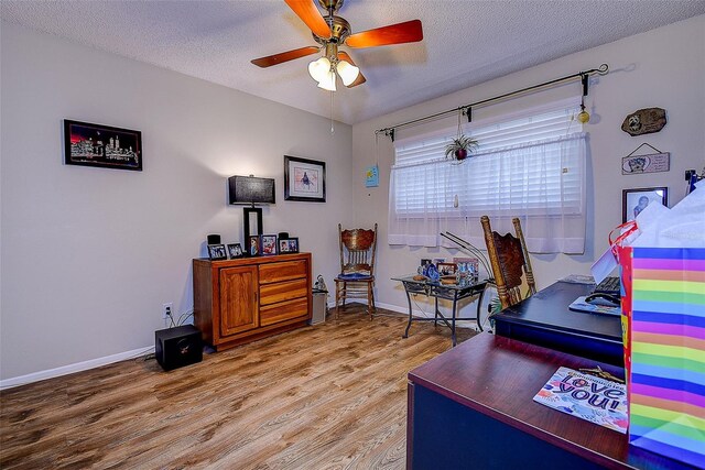5920 80th St N Unit 107, Saint Petersburg, FL 33709 - home office with baseboards, a ceiling fan, light wood-style floors, and a textured ceiling