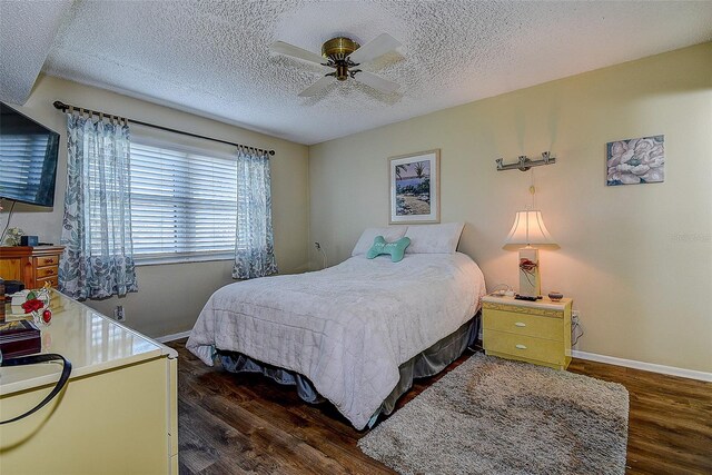 5920 80th St N Unit 107, Saint Petersburg, FL 33709 - bedroom with baseboards, wood finished floors, a textured ceiling, and ceiling fan
