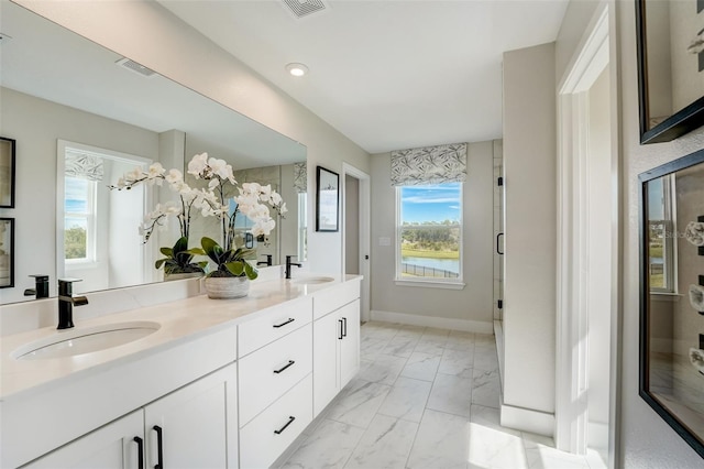 full bath featuring a sink, visible vents, marble finish floor, and double vanity