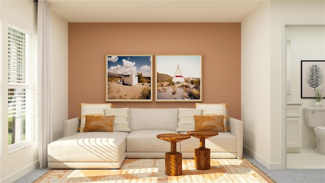 living area featuring carpet and baseboards