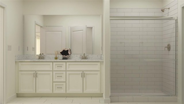 bathroom with a shower stall, double vanity, and a sink