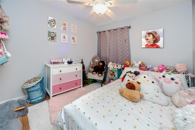 bedroom with a ceiling fan and carpet flooring