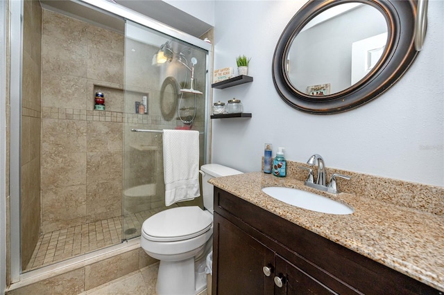 full bathroom with a shower stall, toilet, and vanity