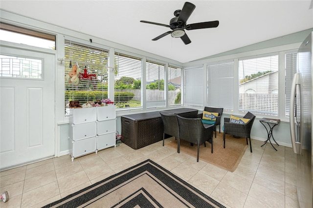 sunroom with a wealth of natural light, a ceiling fan, and vaulted ceiling