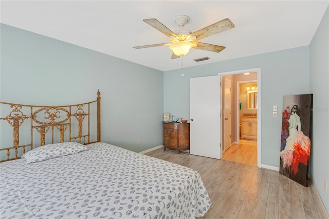 bedroom featuring visible vents, baseboards, wood finished floors, and a ceiling fan