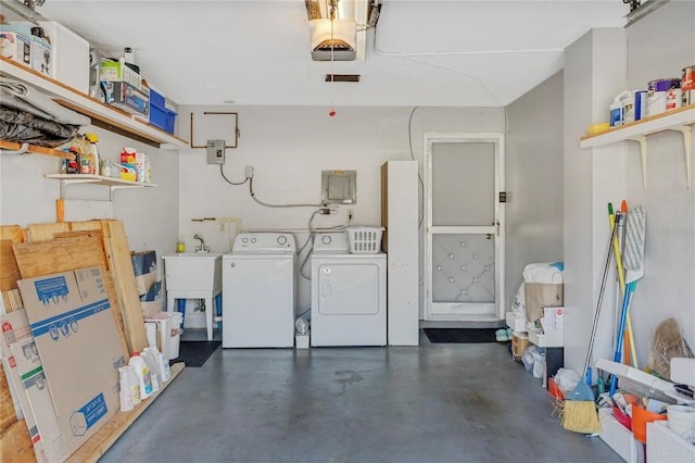 interior space featuring a garage door opener, washing machine and dryer, and a sink