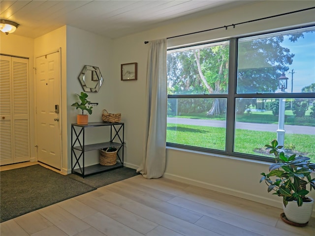 entryway featuring baseboards and wood finished floors