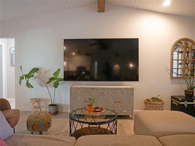 living area with lofted ceiling with beams, baseboards, wood finished floors, and wooden ceiling