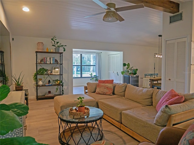 living room featuring light wood finished floors, visible vents, baseboards, and ceiling fan