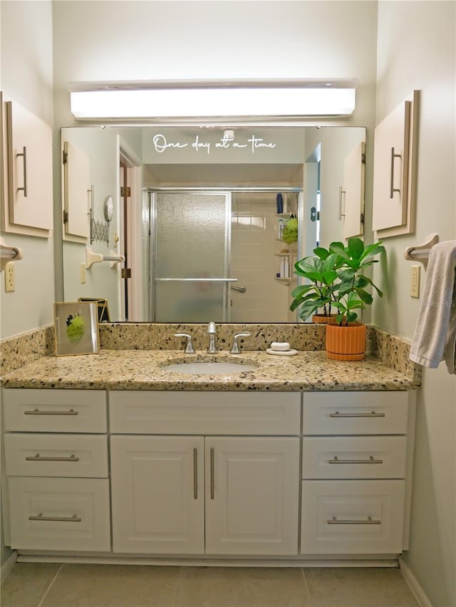 bathroom with vanity, a shower stall, and tile patterned flooring