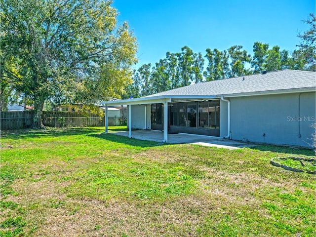 view of yard featuring fence and a patio area