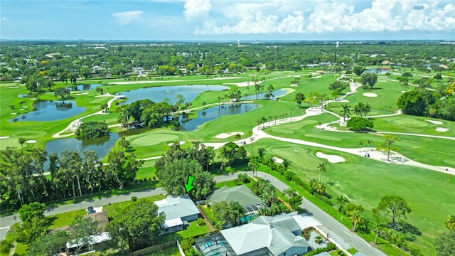 drone / aerial view with a water view and view of golf course