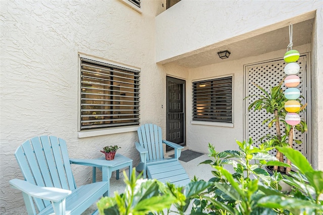 doorway to property featuring stucco siding