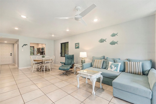 living room featuring light tile patterned floors, recessed lighting, baseboards, and ceiling fan