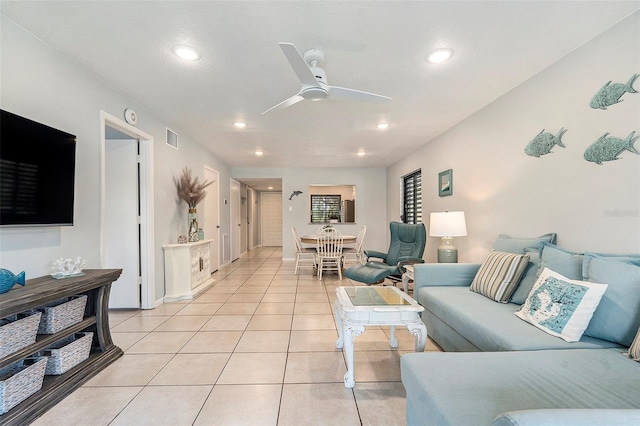 living area featuring light tile patterned floors, visible vents, ceiling fan, and recessed lighting