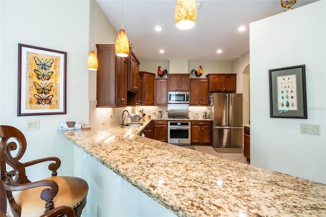 kitchen with a sink, light stone counters, recessed lighting, appliances with stainless steel finishes, and decorative backsplash