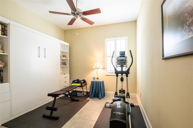 workout room featuring a ceiling fan and baseboards