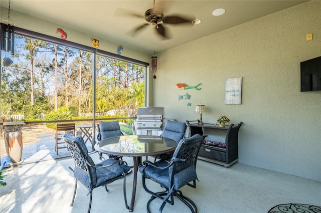 sunroom featuring a ceiling fan