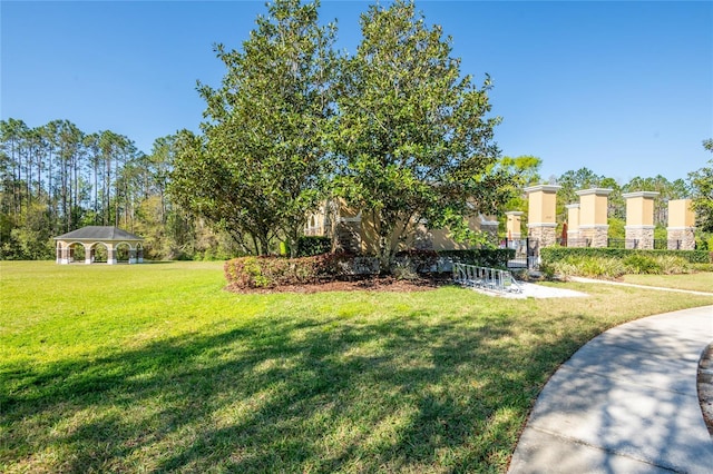 surrounding community with a gazebo and a yard